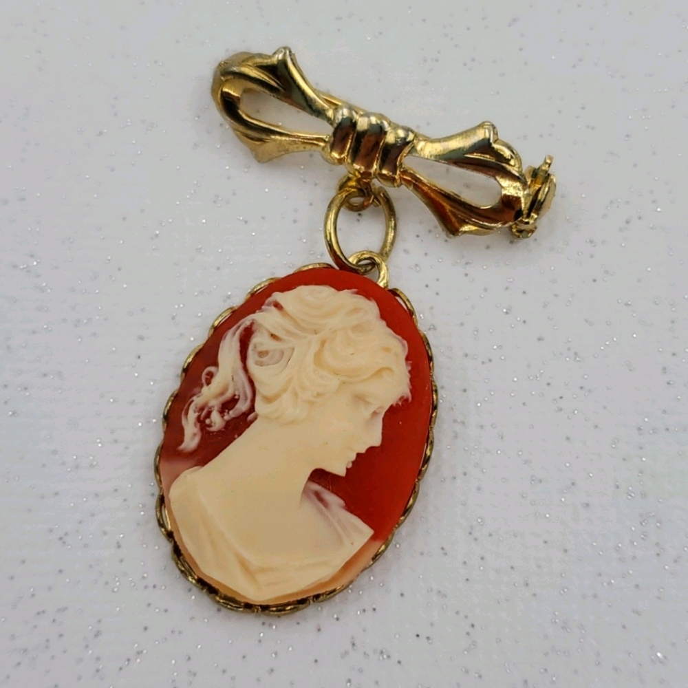 Orange Cameo on Gold Tone Ribbon Brooch